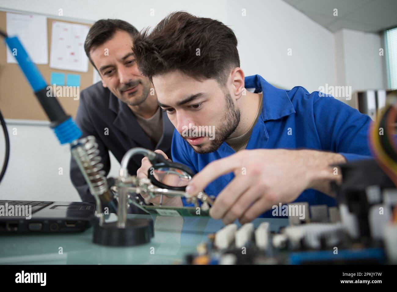 technician fitting component into computer Stock Photo