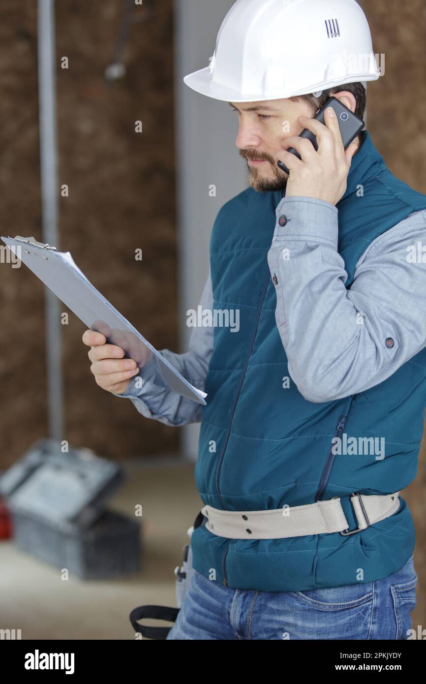 smiling foreman talking on cell phone Stock Photo