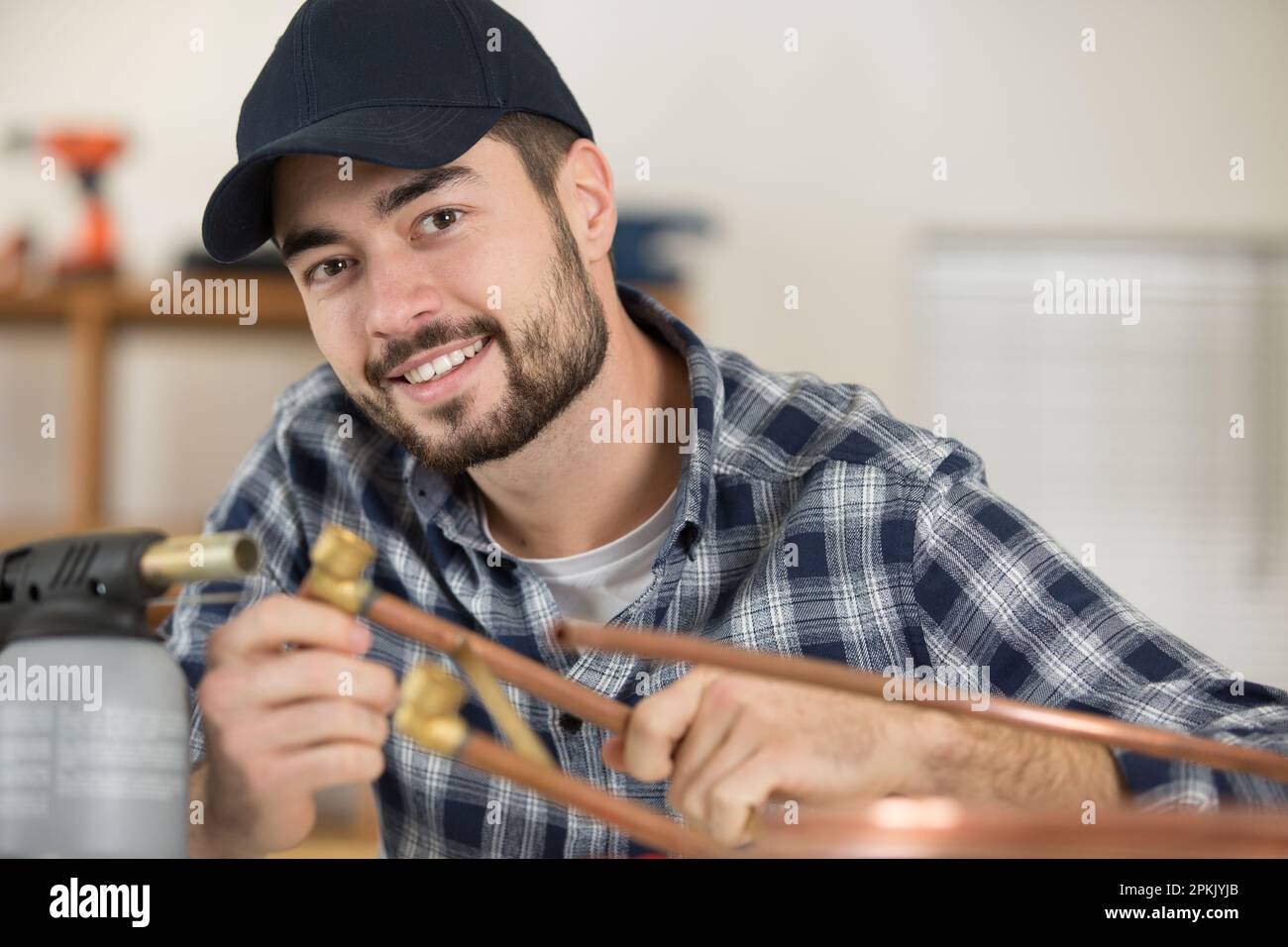 worker is soldering a pipe by a blow torch Stock Photo Alamy
