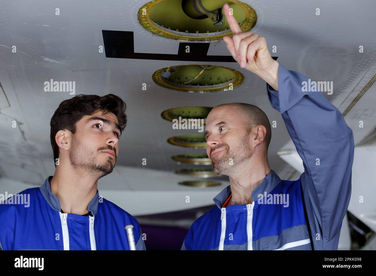 two airport worker checking chassis Stock Photo