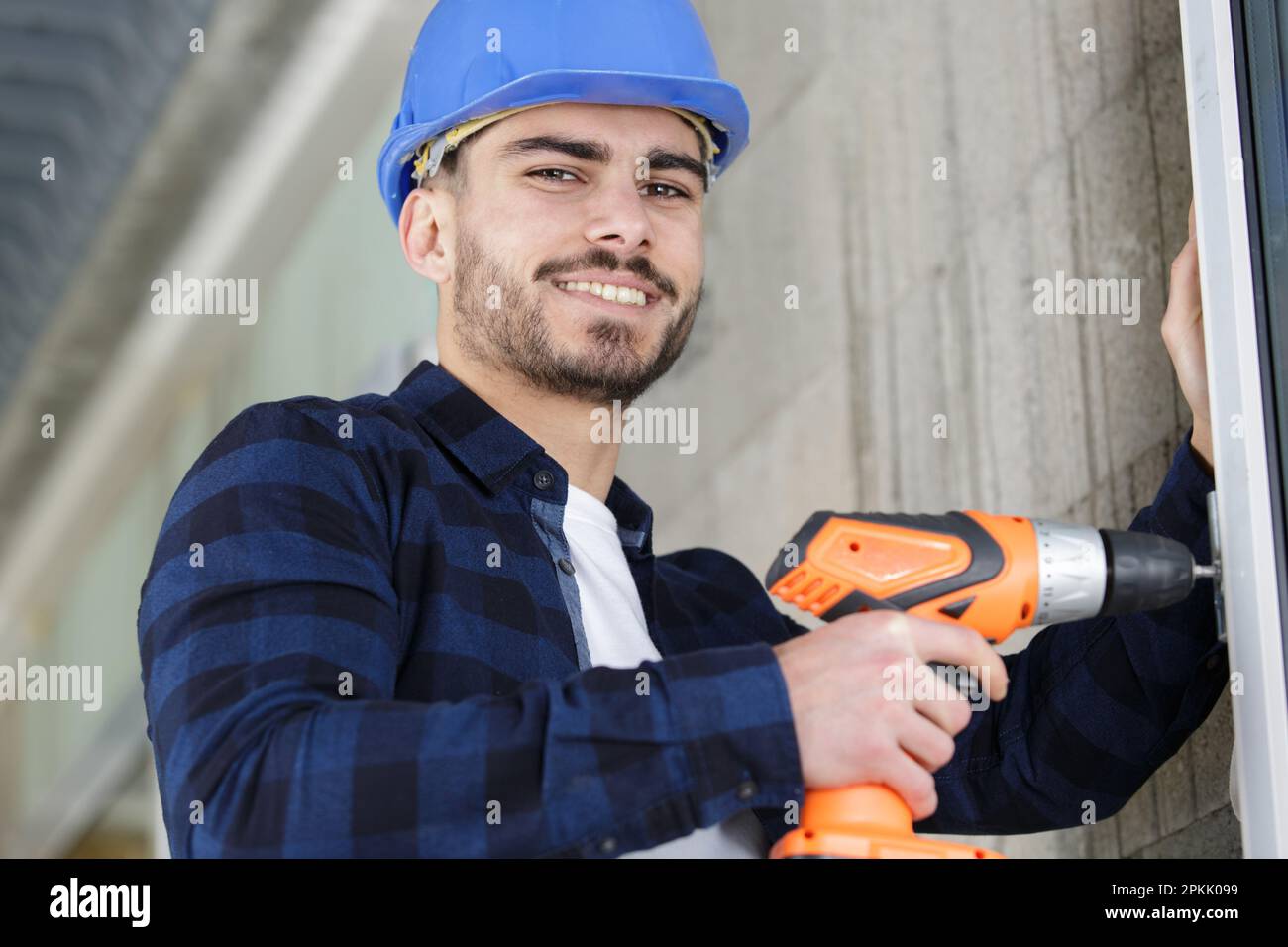 working man builder using electric screwdriver indoors Stock Photo Alamy