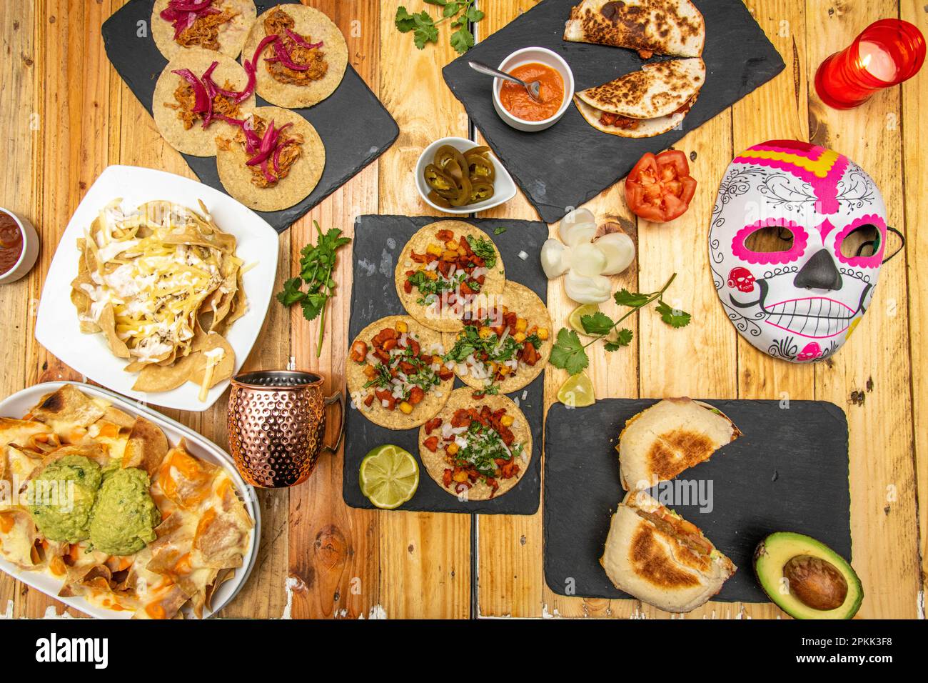 Set of great Mexican food recipes with tacos al pastor, cochinita pibil tacos, nachos with guacamoles, quesadillas on wooden table Stock Photo