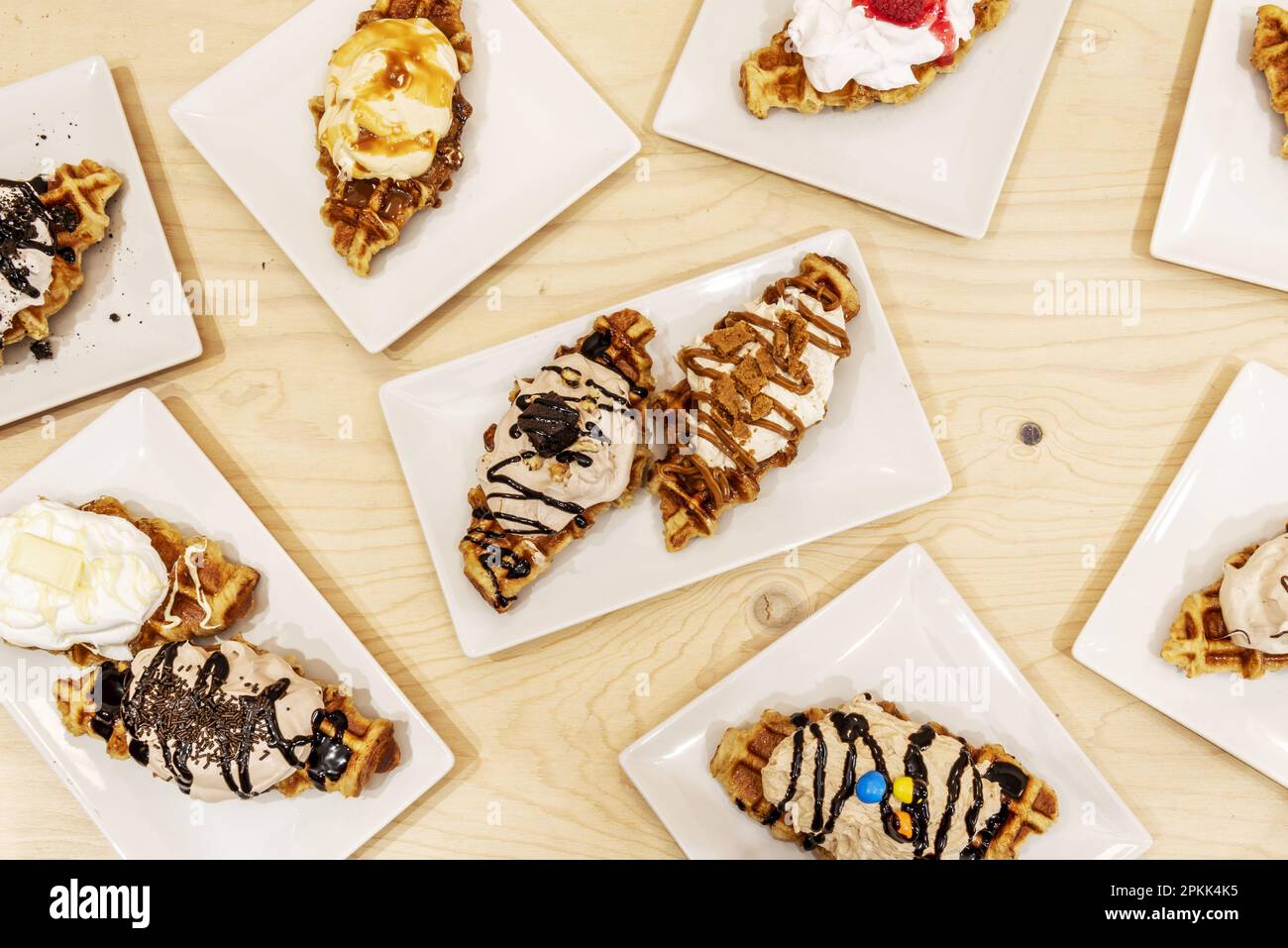 Sweet desserts with a lot of whipped cream, cream, sweet syrups and chocolate bars Stock Photo