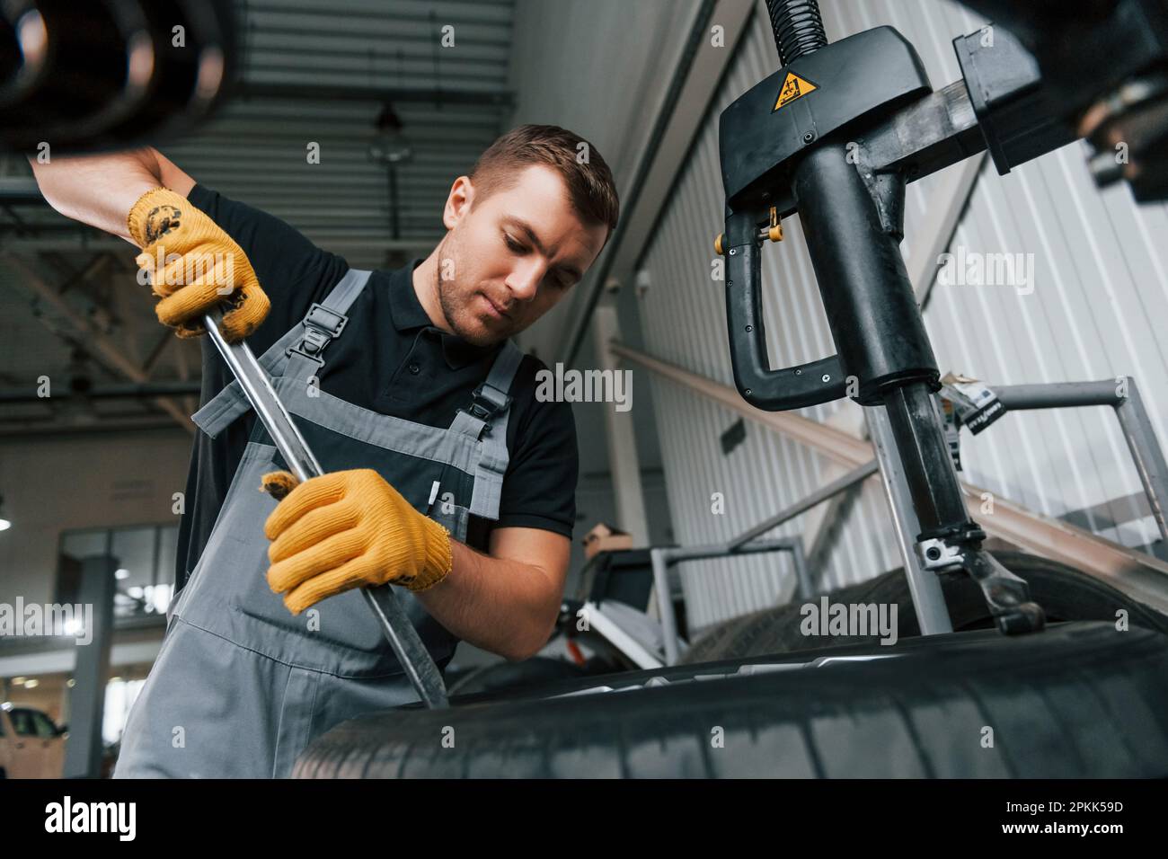 Employee at work. Man in uniform is in the auto service Stock Photo - Alamy