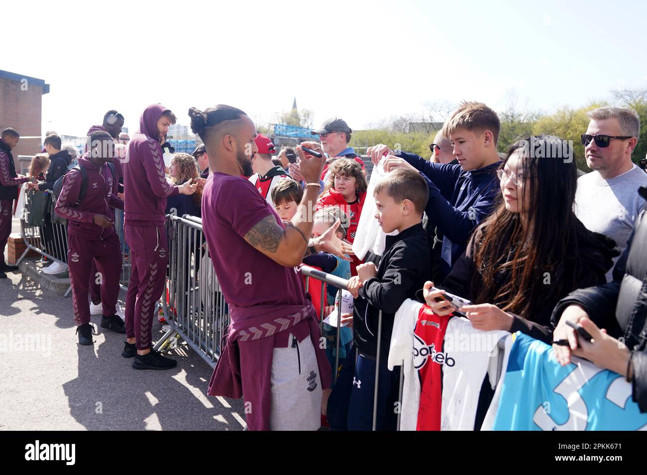 Southampton's Theo Walcott signs autographs for fans outside the