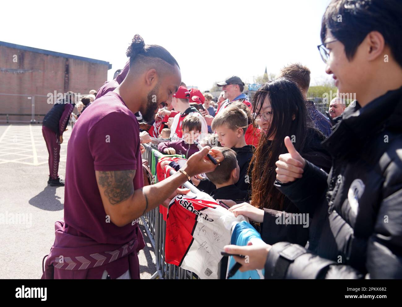 Southampton's Theo Walcott signs autographs for fans outside the