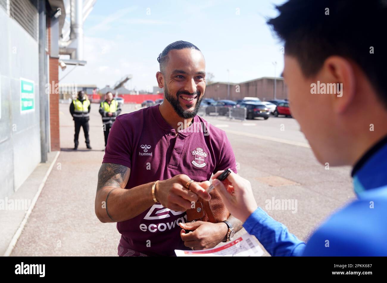 Southampton's Theo Walcott signs autographs for fans outside the