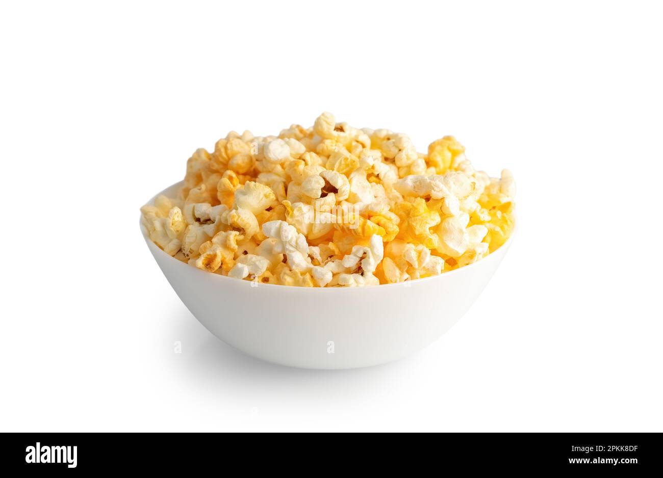 Tasty cheese popcorn in bowl isolated on white background close up. Movies, cinema and entertainment concept. Stock Photo