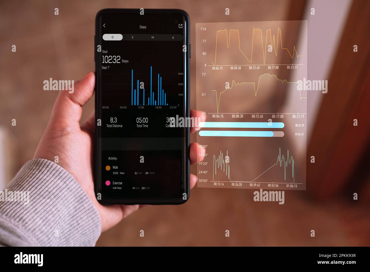 Woman checking her daily activity on smartphone with VR screen interface. Futuristic exercise concept. Stock Photo