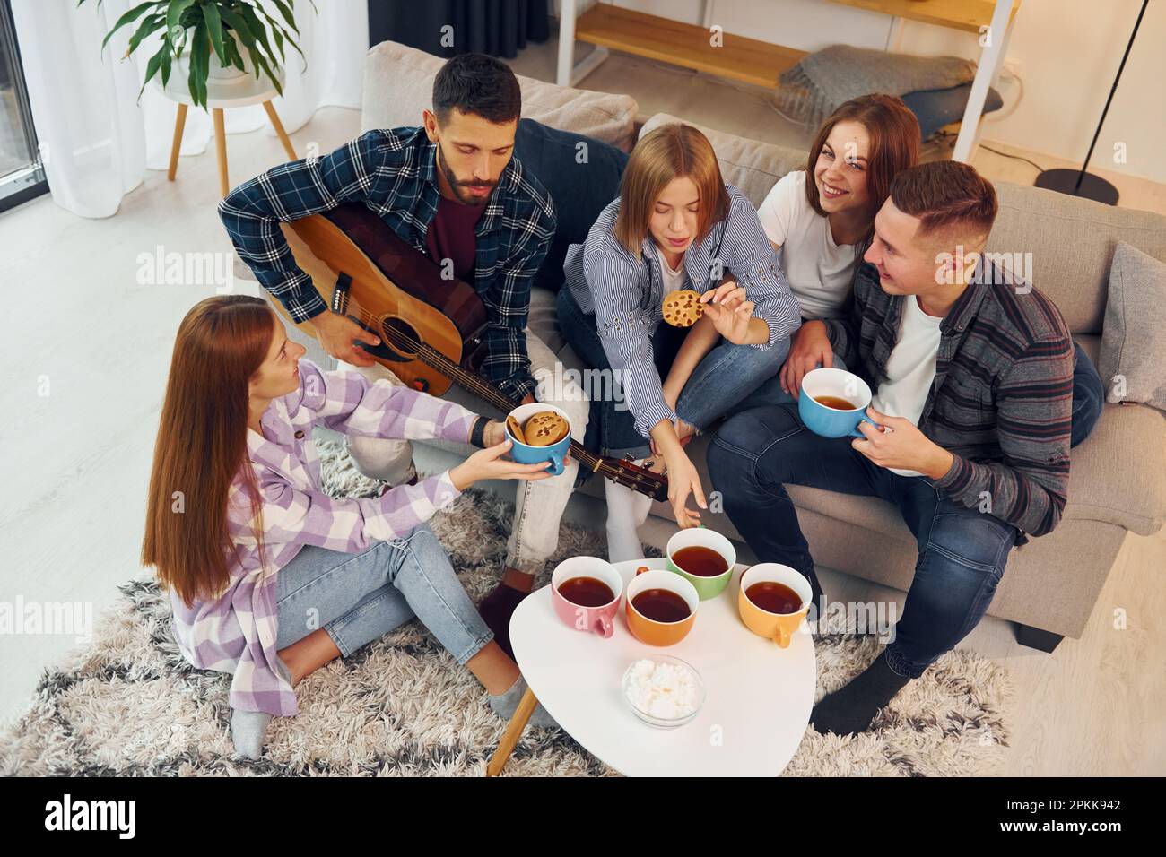Weekend rest. Group of friends have party indoors together Stock Photo ...