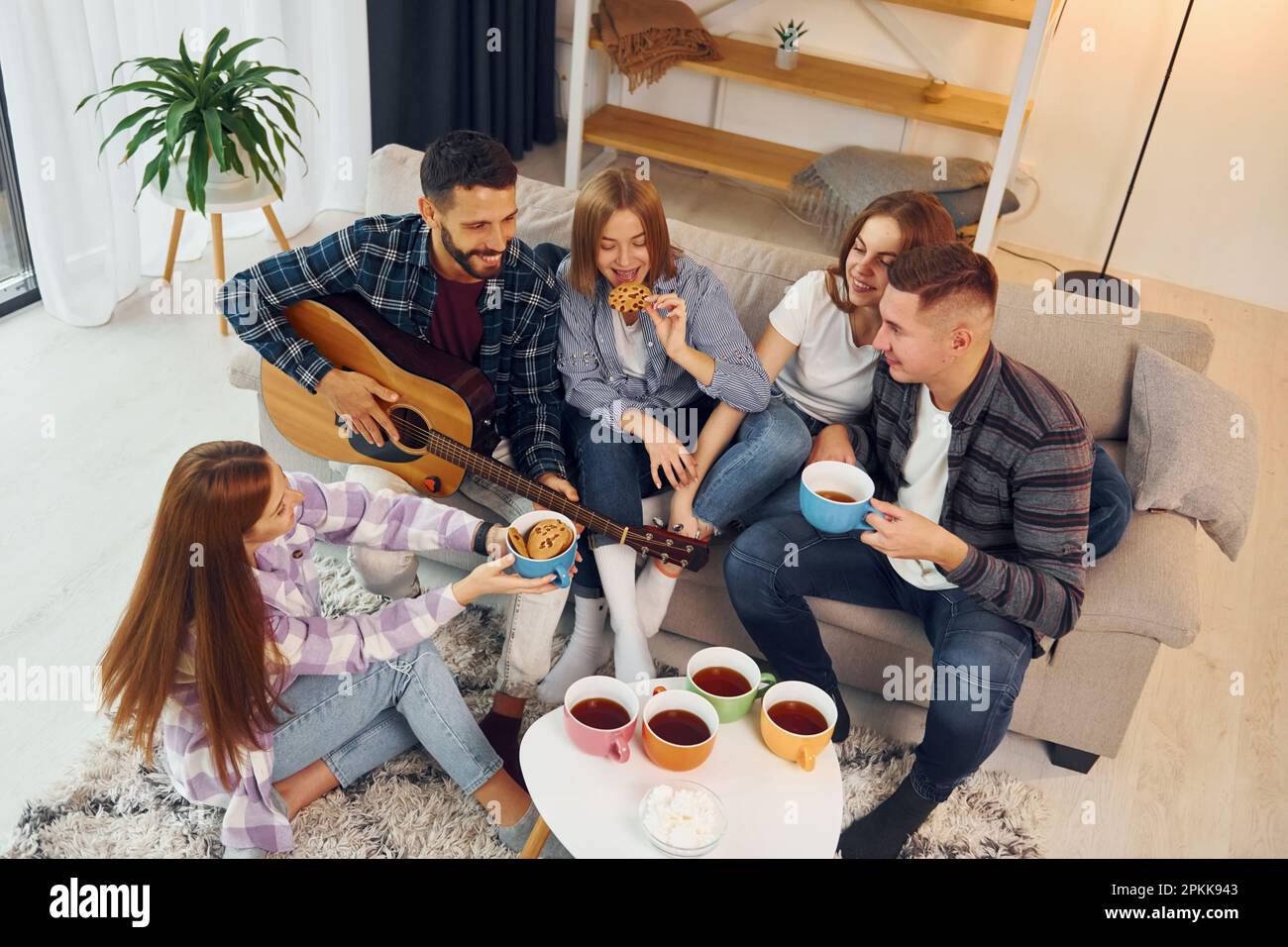 Weekend rest. Group of friends have party indoors together Stock Photo ...