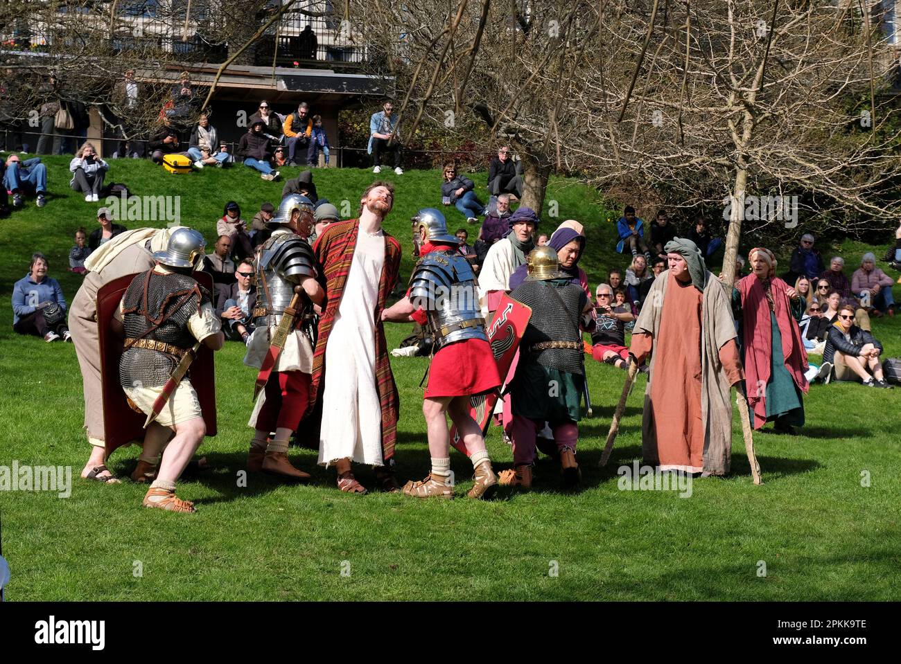 Edinburgh, Scotland, UK. 8th April 2023.  Bringing the Easter Story to life, a traditional passion play in full costume, featuring Jesus’ life, death and Resurrection, all played out in West Princes Street Gardens beneath the iconic backdrop of Edinburgh Castle. Featuring the soldiers of the Antonine Guard. Jesus being arrested by Roman soldiers in the Garden of Gethsemane. Credit: Craig Brown/Alamy Live News Stock Photo