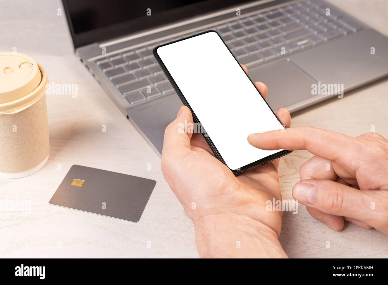 Hand holding mobile phone mockup, clicking tapping on smartphone screen frame and credit card mock-up for paying online. Bank application ad. Stock Photo