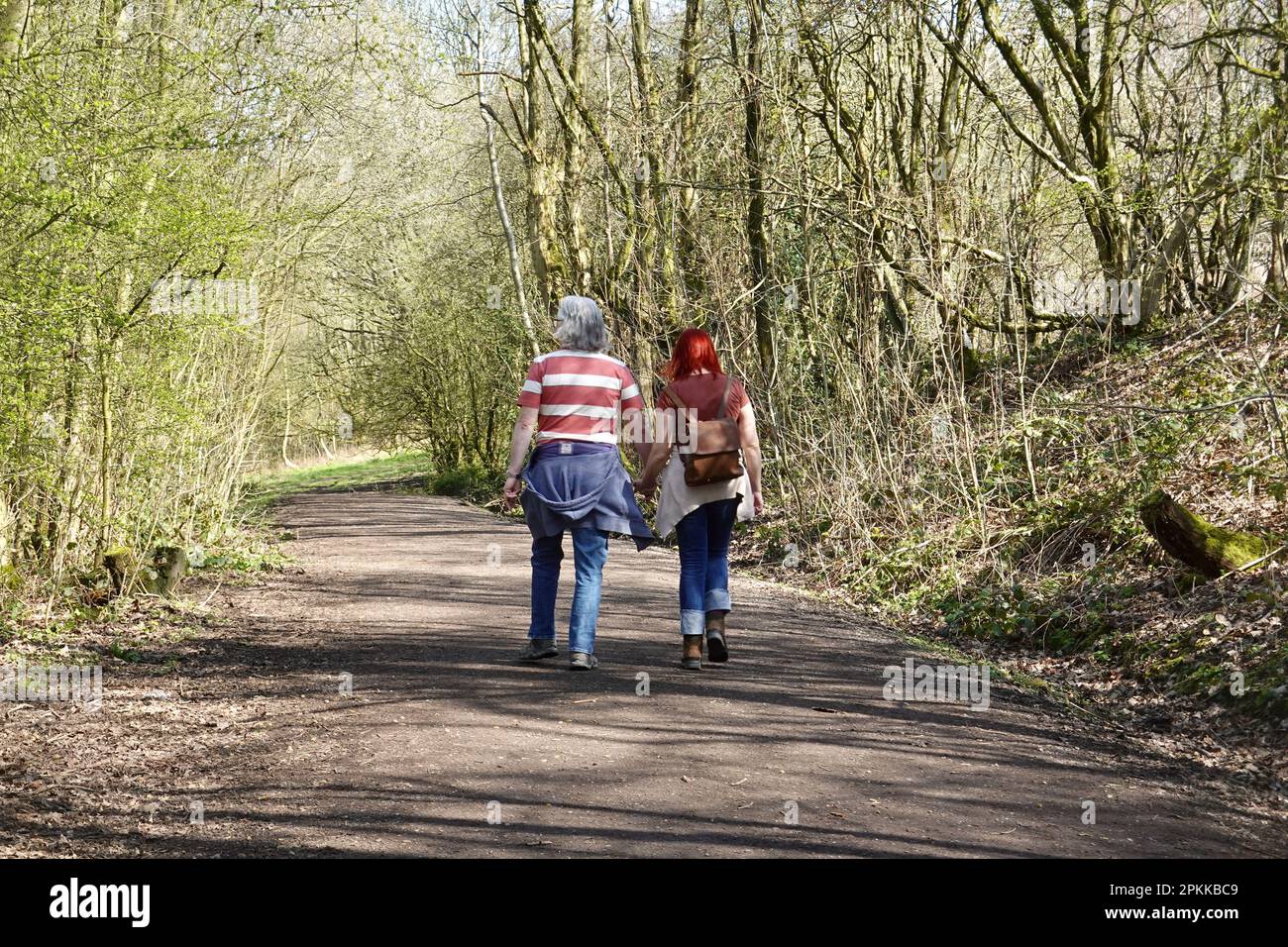 Couple walk hand-in-hand on the Sett Valley Trail, Derbyshire Stock Photo