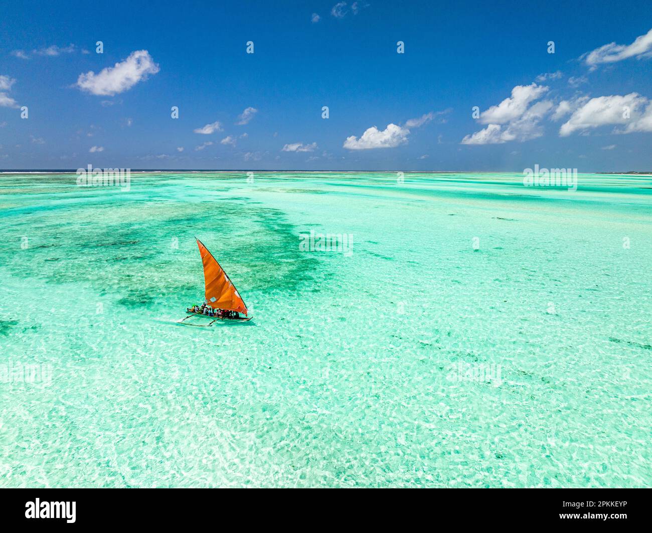 Aerial view of a dhow sailing in the transparent lagoon, Paje, Jambiani, Zanzibar, Tanzania, East Africa, Africa Stock Photo