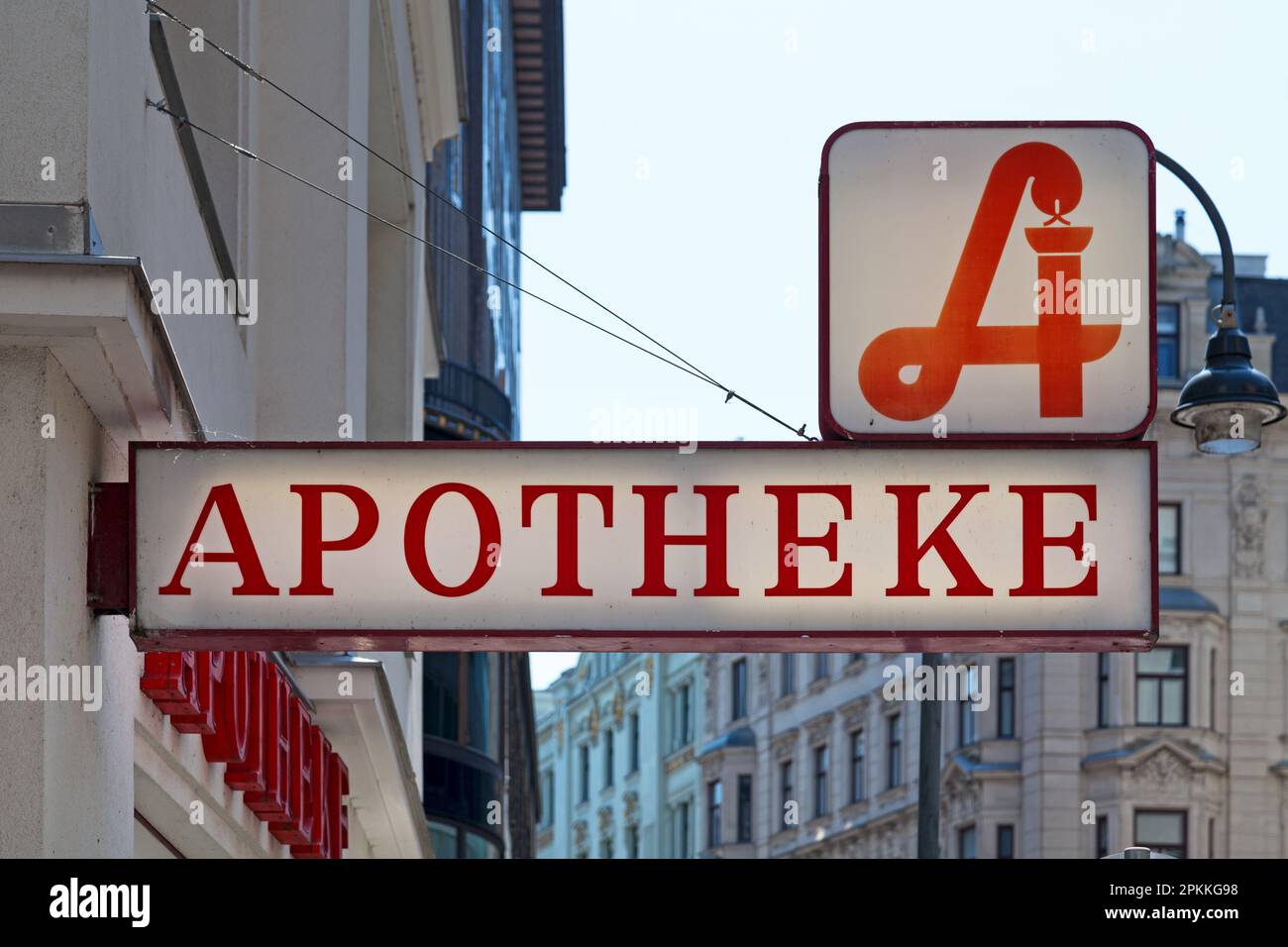 Austrian pharmacy displaying the traditional pharmacy sign above a second sign 'Apotheke', meaning in English 'Pharmacy'. Stock Photo