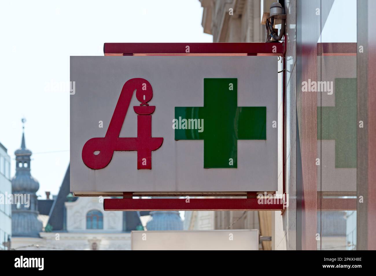 Austrian pharmacy displaying the traditional pharmacy sign used in the country next to the standard green cross. Stock Photo