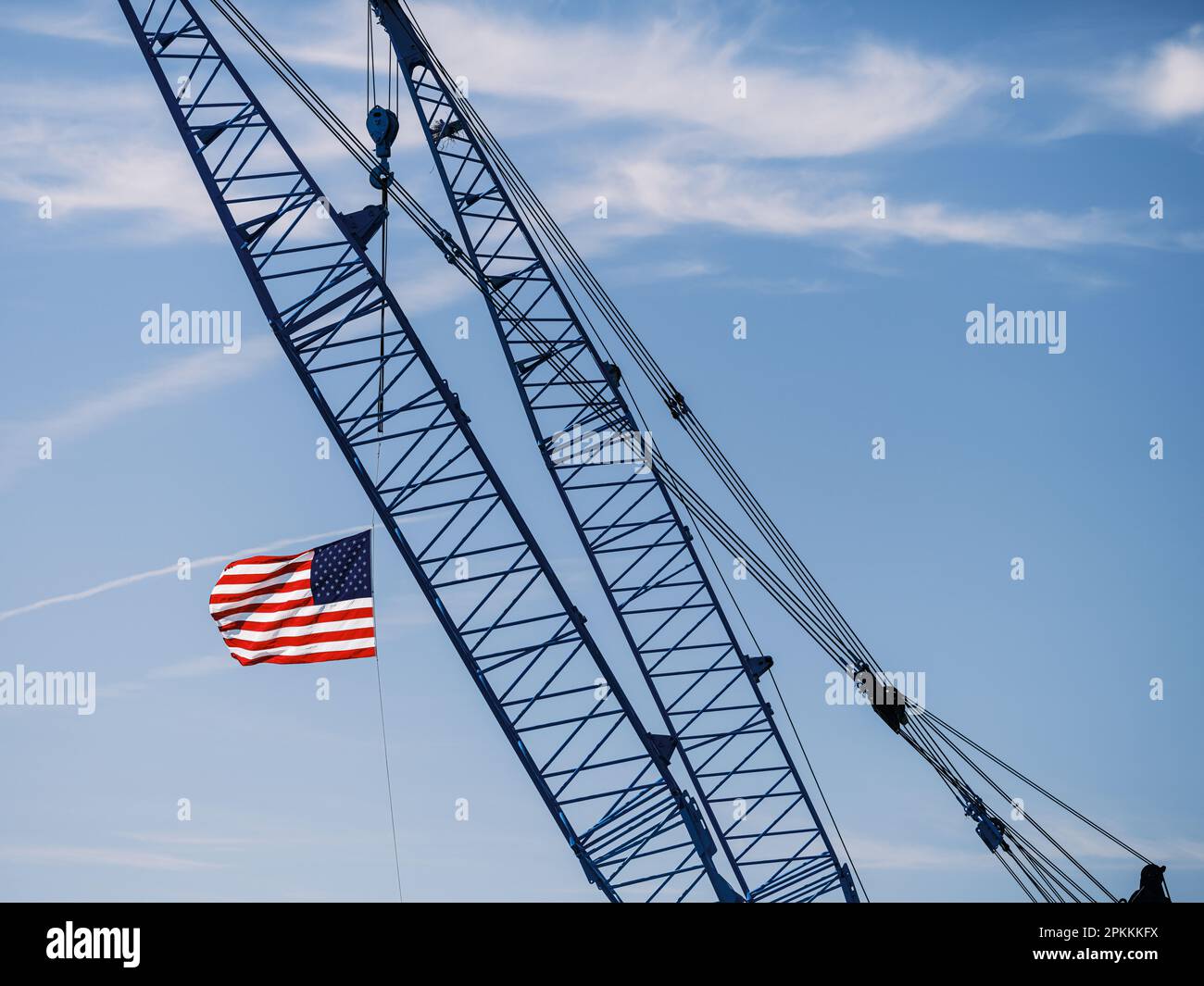 American flag hanging from crane hires stock photography and images