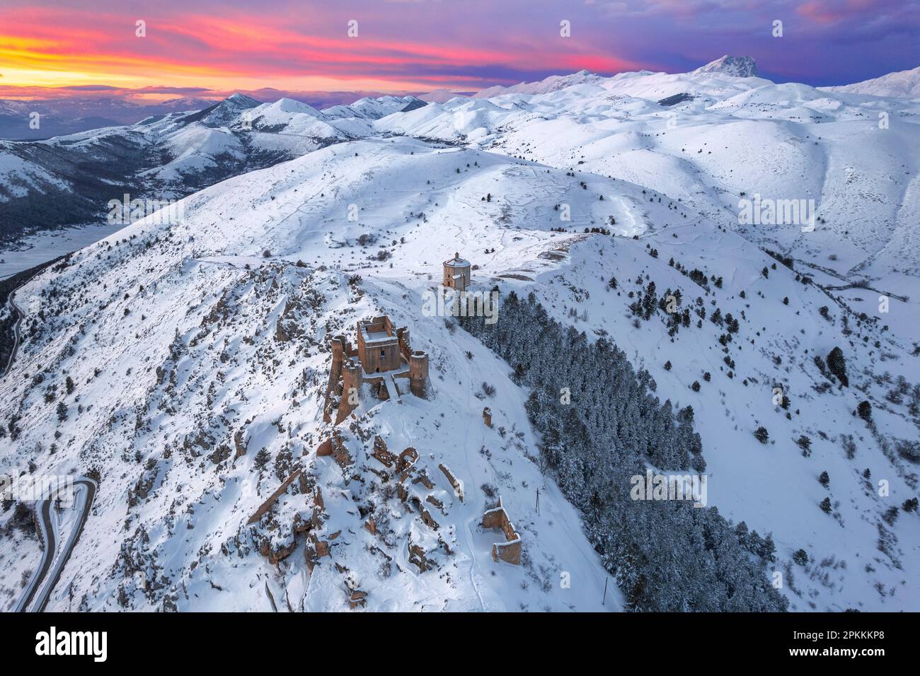 Aerial winter view of the snow covered Rocca Calascio castle and church of Santa Maria della Pieta Stock Photo