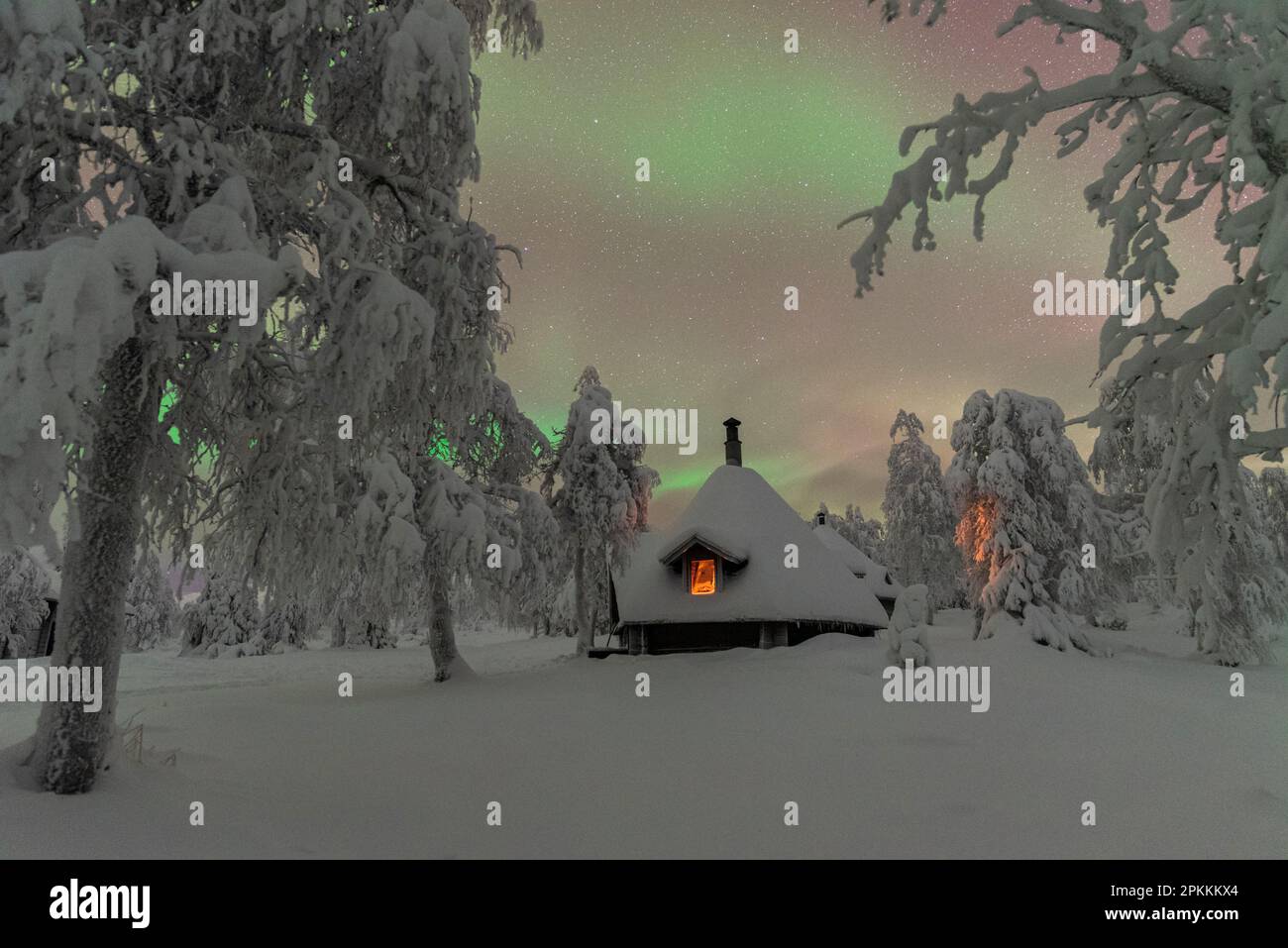 Typical wooden illuminated hut under the Northern Lights (Aurora ...