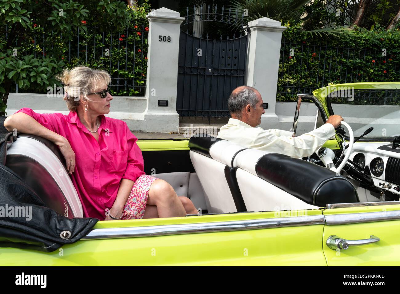 Attractive female Western tourist being driven around in open top Chevrolet classic car, Havana, Cuba, West Indies, Caribbean, Central America Stock Photo