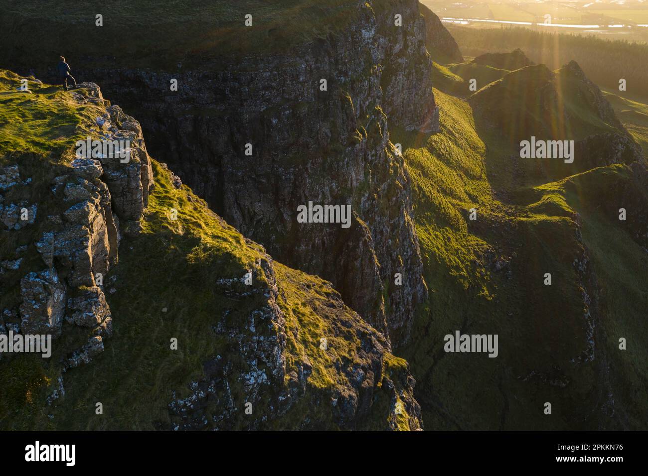 Man standing on the cliff edge of Binevenagh mountain, County Antrim, Ulster, Northern Ireland, United Kingdom, Europe Stock Photo