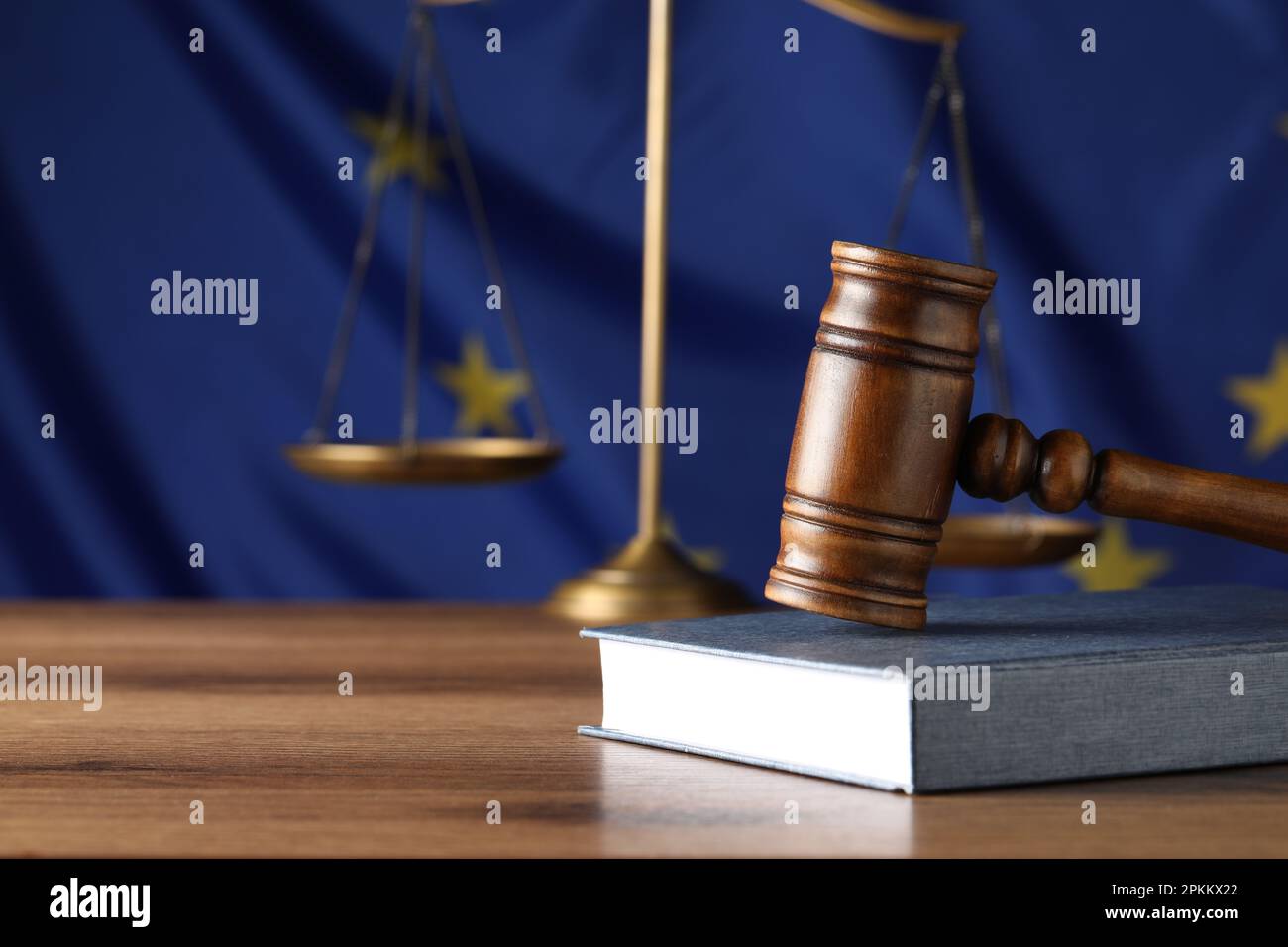 Judge's gavel and book on wooden table against European Union flag ...