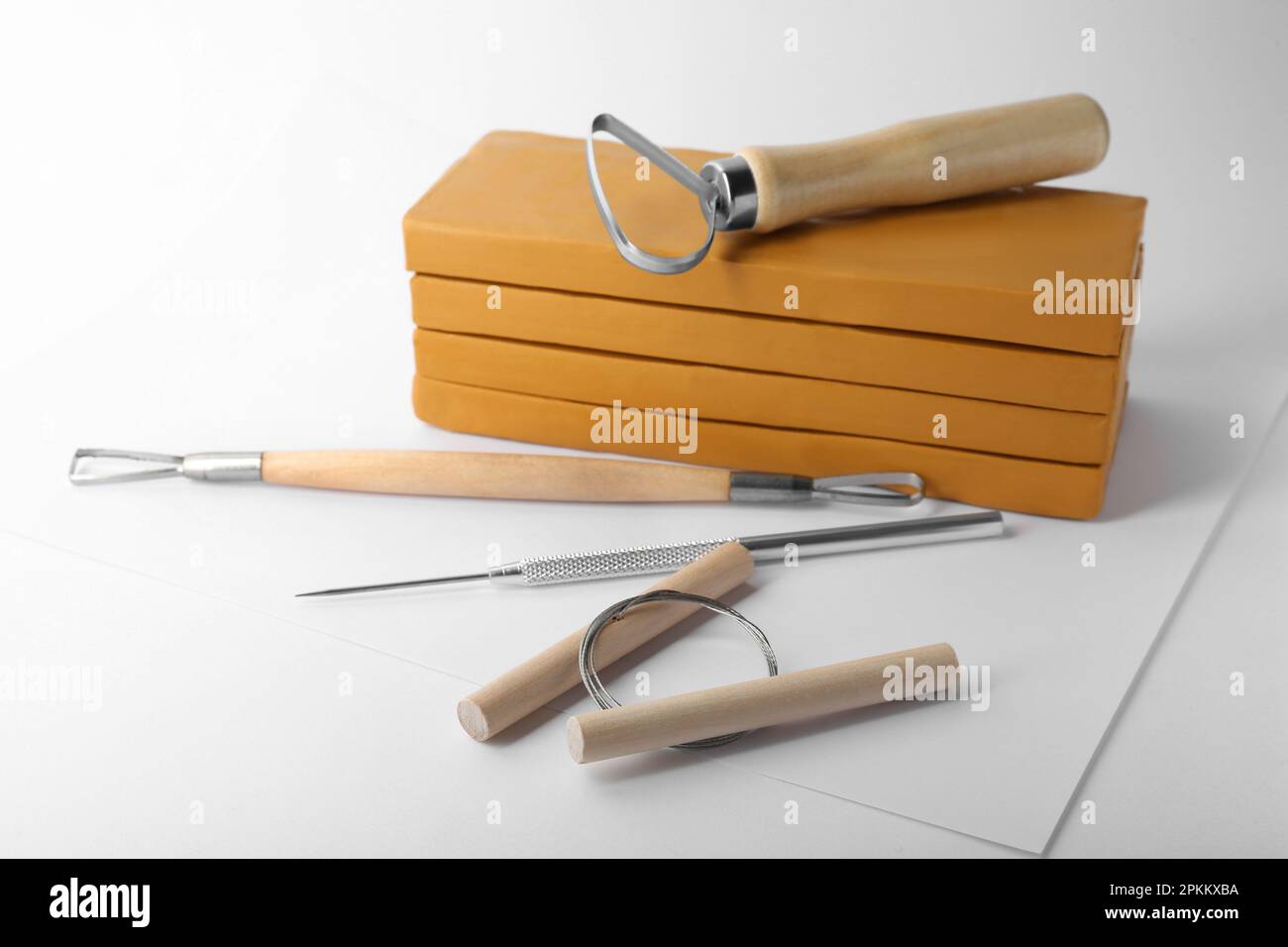 Clay and different modeling tools on white background Stock Photo - Alamy