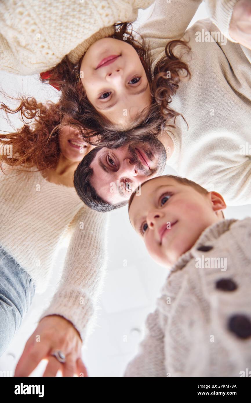 View from below. Happy family looking down and having fun. Stock Photo