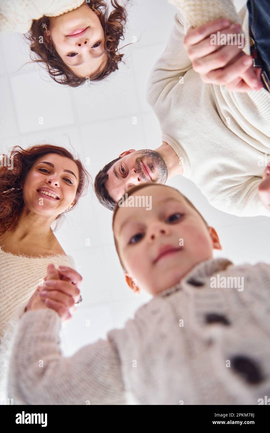 View from below. Happy family looking down and having fun. Stock Photo