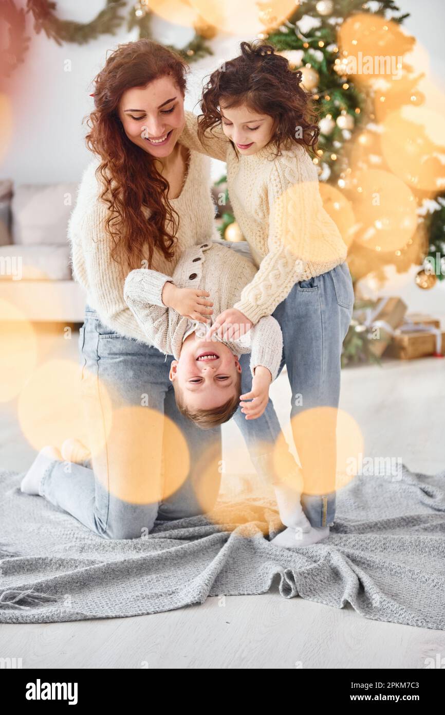 Mother celebrating new year with her children at home. Stock Photo