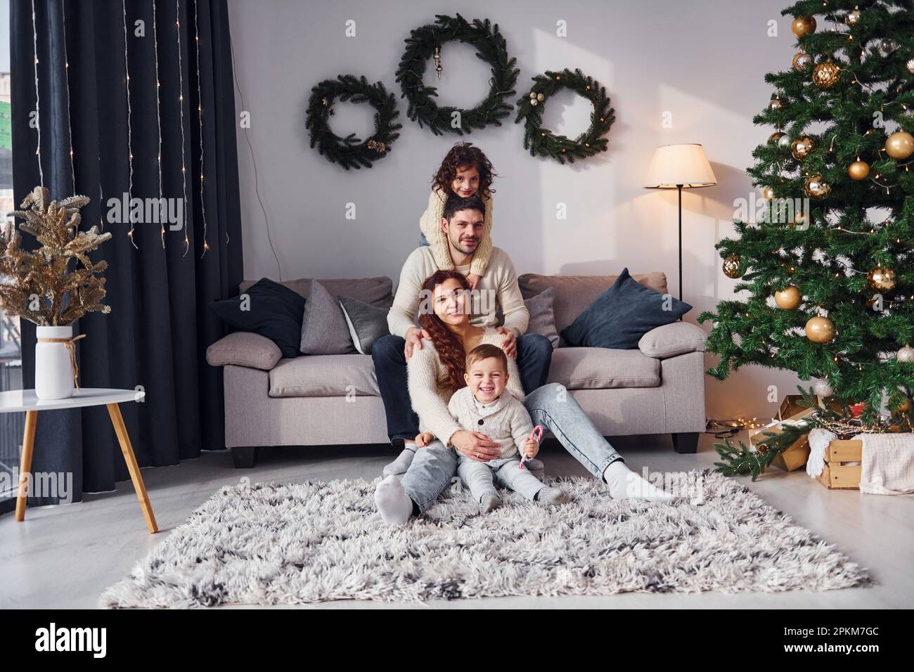 Conception of holidays. Family celebrating new year with their children at home. Stock Photo
