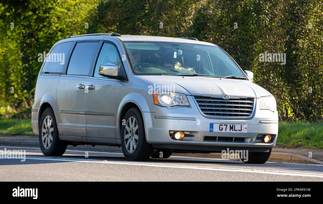 2011 silver CHRYSLER  GRAND VOYAGER  car travelling on an English country road Stock Photo