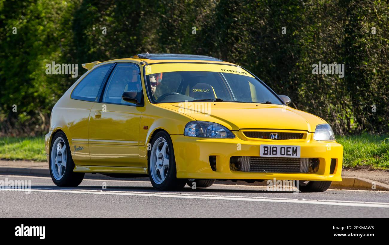 1999 yellow Honda Civic car travelling on an English country road Stock Photo