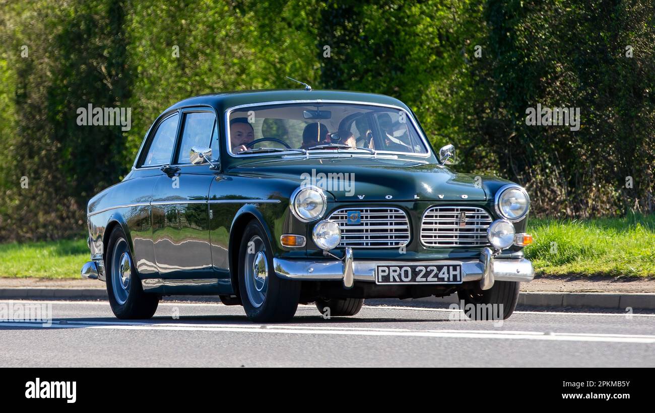 1970 green Volvo Amazon classic car travelling on an English country road Stock Photo