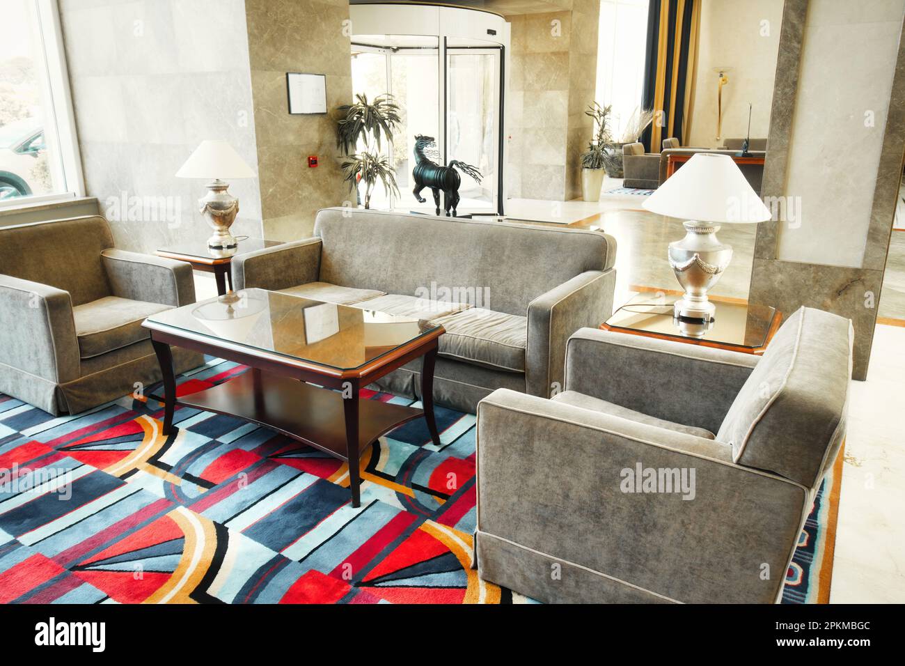 A lobby of a posh 5-star hotel with comfortable sofa and chairs with marble floor and walls Stock Photo