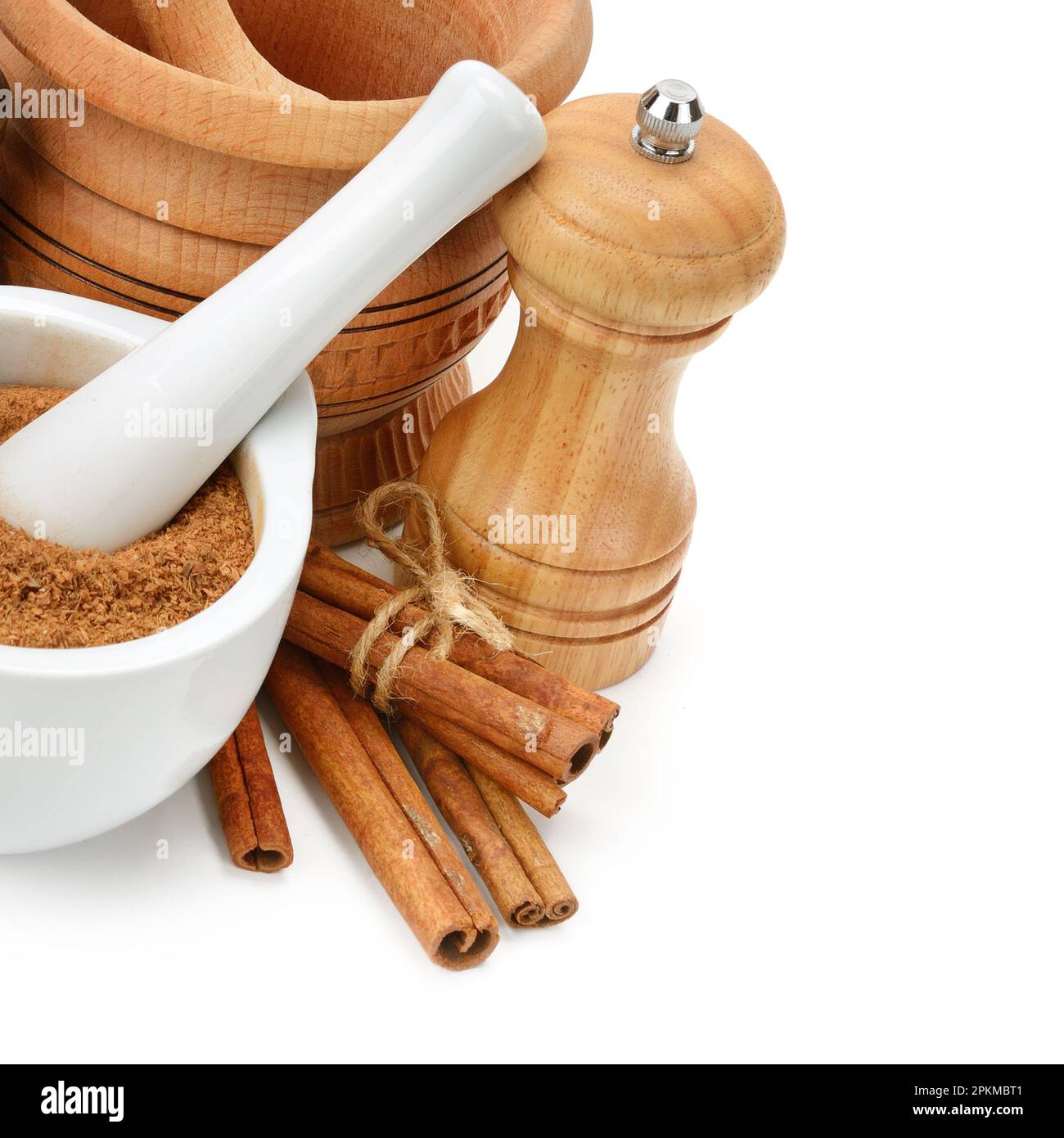 Cinnamon, mortar and pestle, hand grinder isolated on white background. Healthy food. Free space