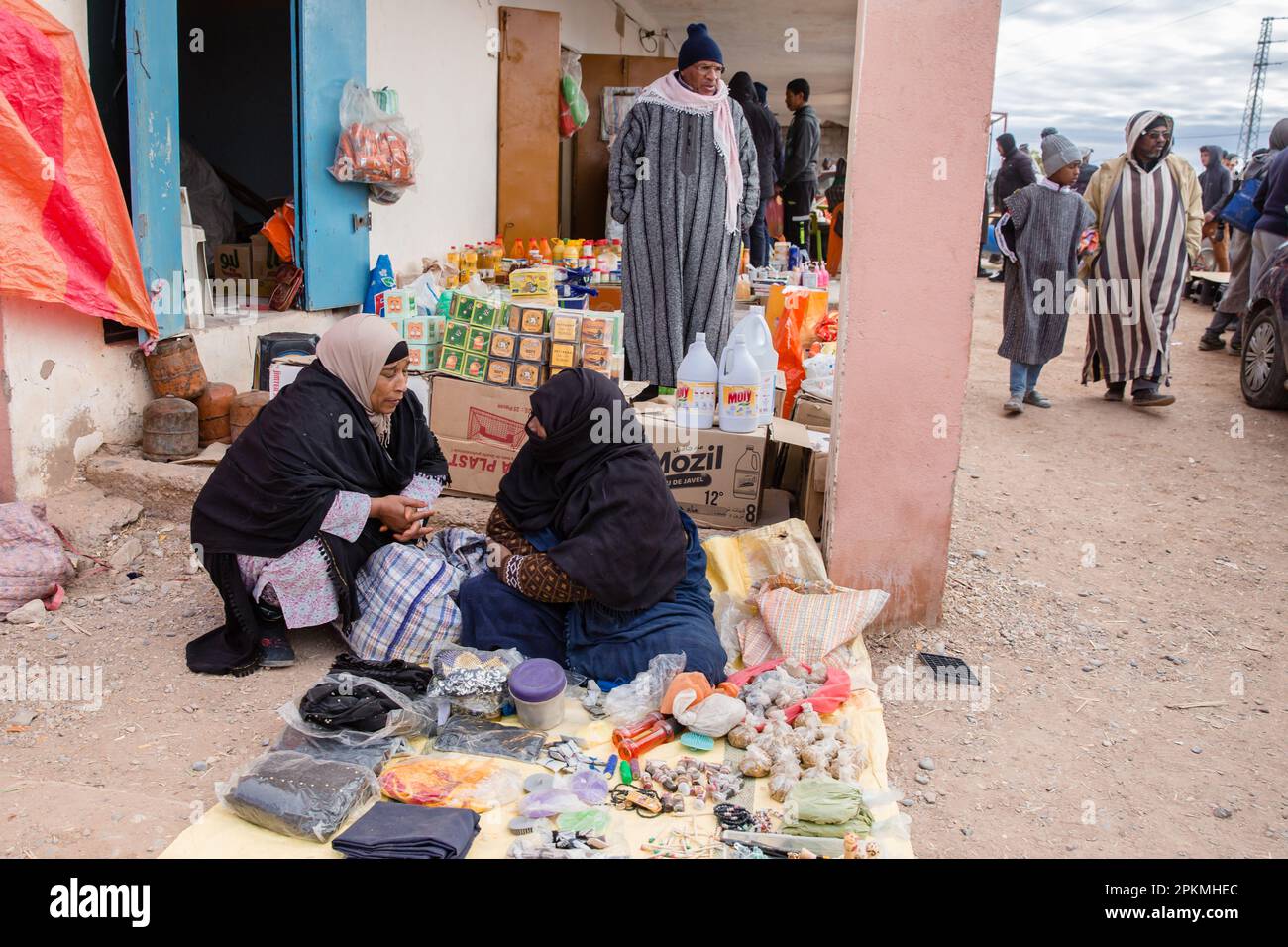 Local Moroccans stroll and sell food at a Berber market Stock Photo