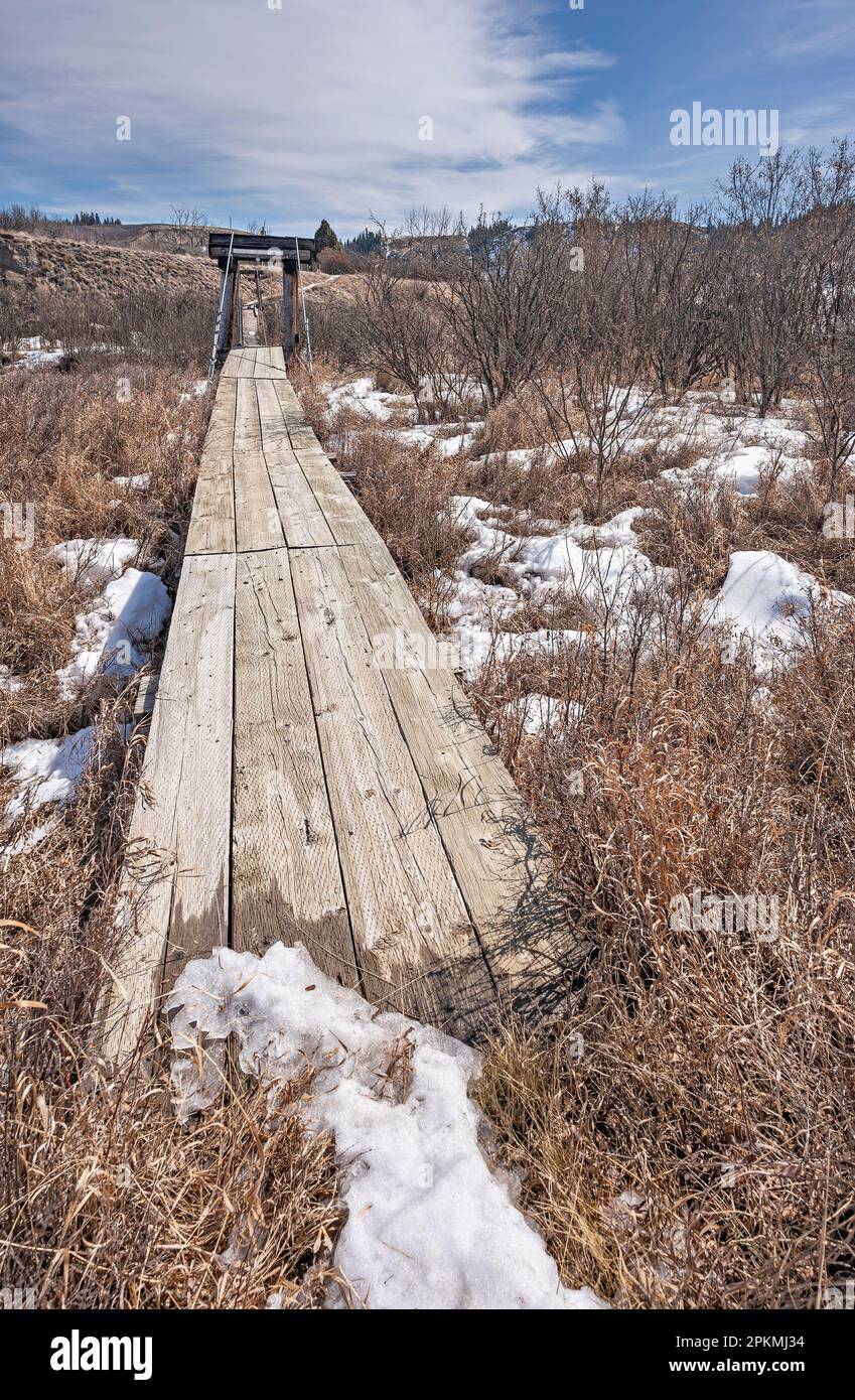 Pedestrian bridge over the Rosebud River at the ghost town of Beynon in Alberta, Canada Stock Photo