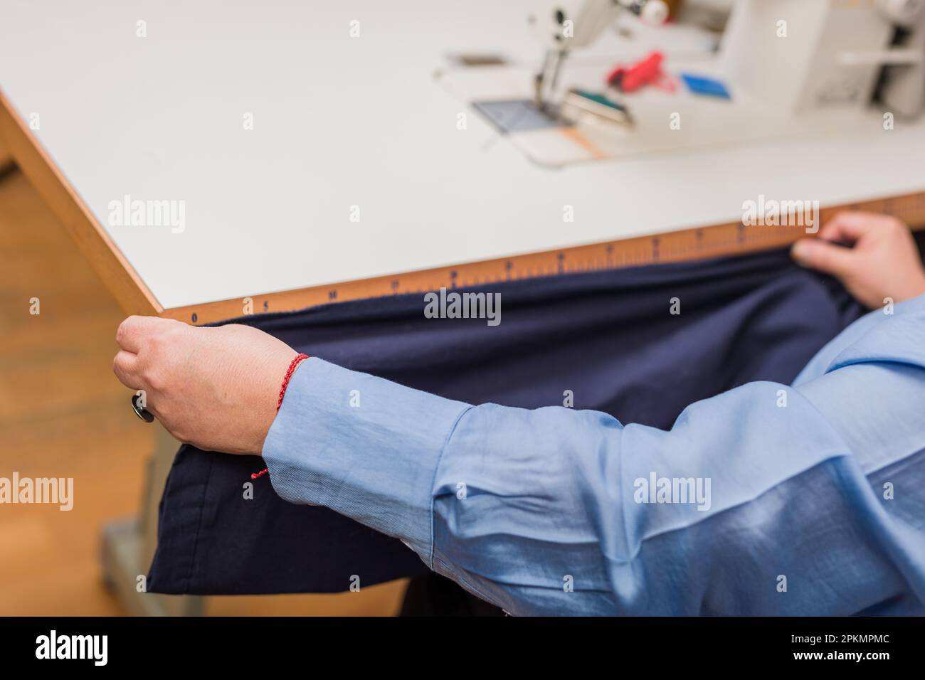 Seamstress measuring tape. working on textile industry fabric close up.  Unrecognizable person Stock Photo - Alamy