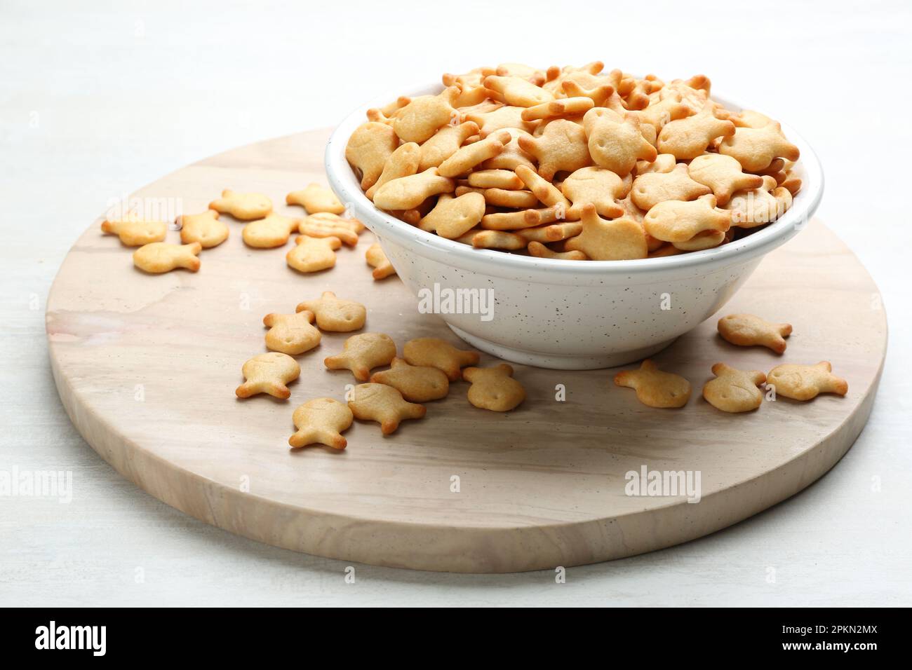 Delicious goldfish crackers in bowl on table Stock Photo