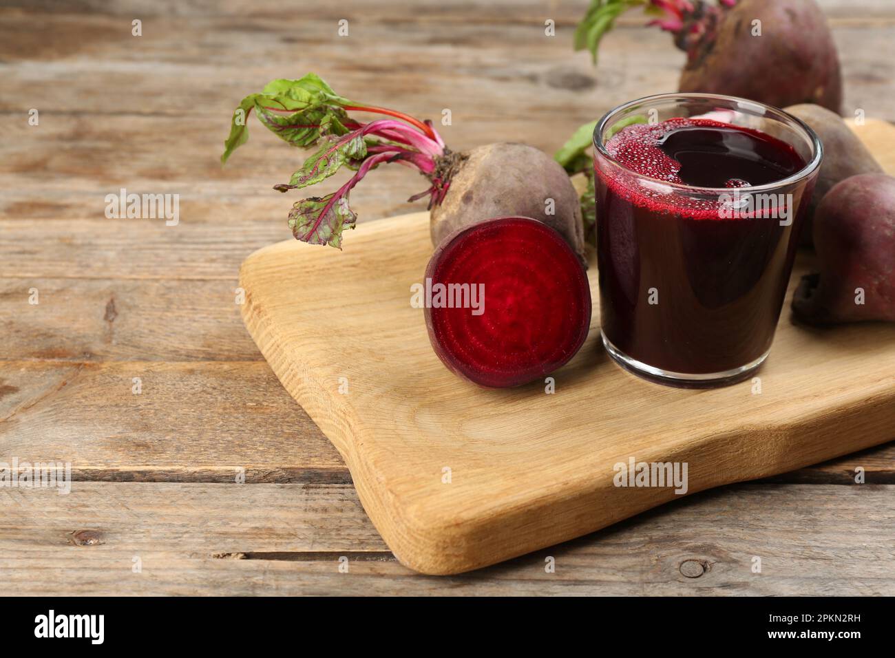 Freshly made beet juice on wooden table Stock Photo
