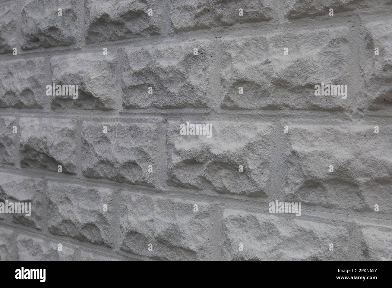 Textured, white cinder block wall. Showing the side of a building Stock ...