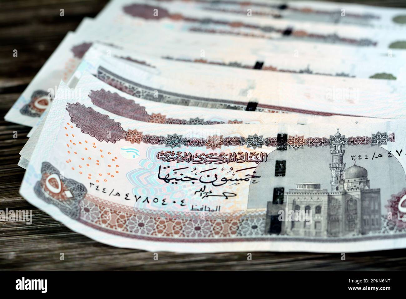 Egypt money stack of pounds isolated on wood background, pile of 50 EGP