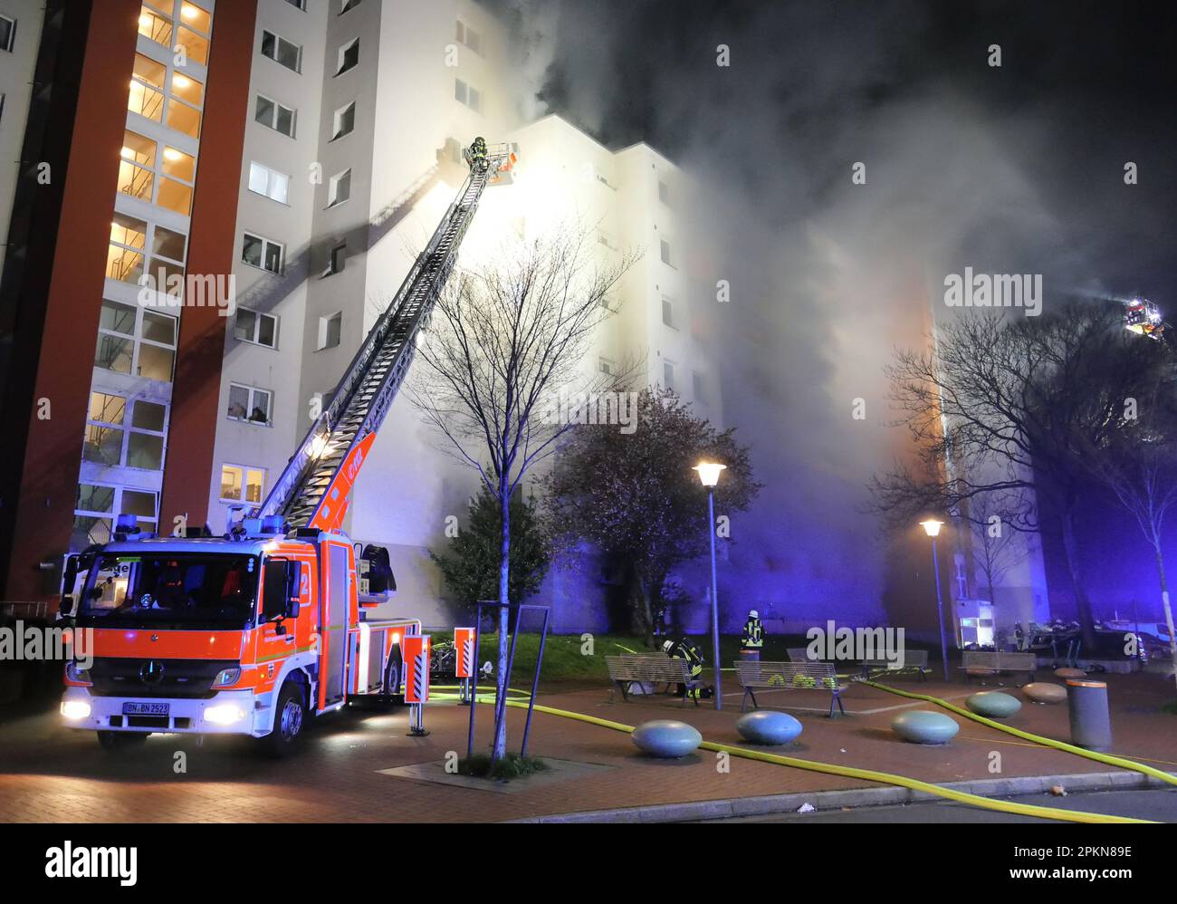 Bonn, Germany. 09th Apr, 2023. Firefighters work on a burning high-rise apartment building in the Tannenbusch district. For the firefighters, this is a major operation with a lot of residents standing in the street for the first time. Credit: Marius Fuhrmann/dpa/Alamy Live News Stock Photo
