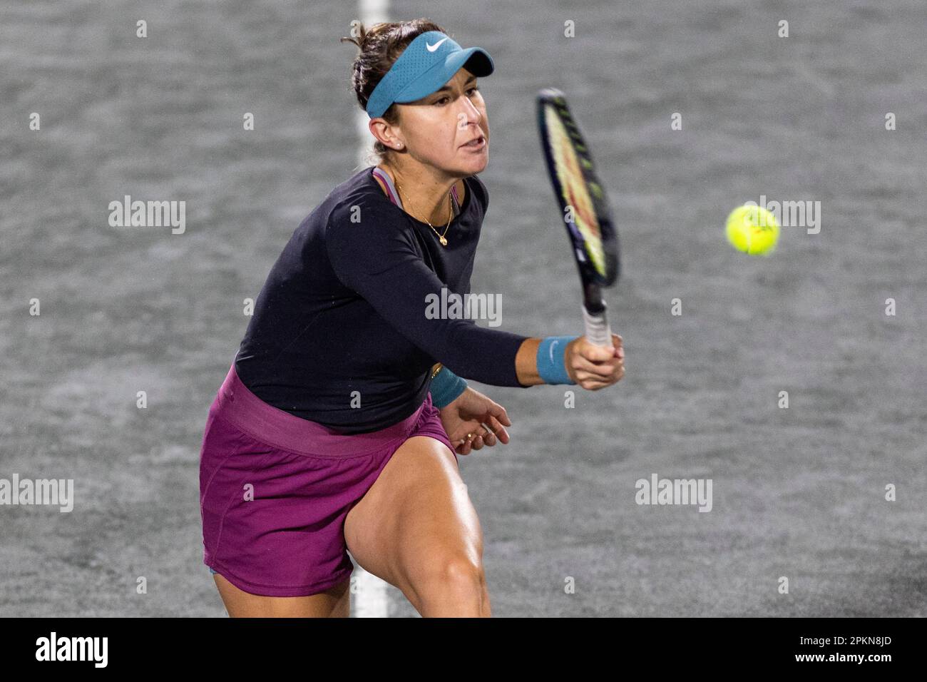 Belinda Bencic, of Switzerland, returns a shot to Jessica Pegula during