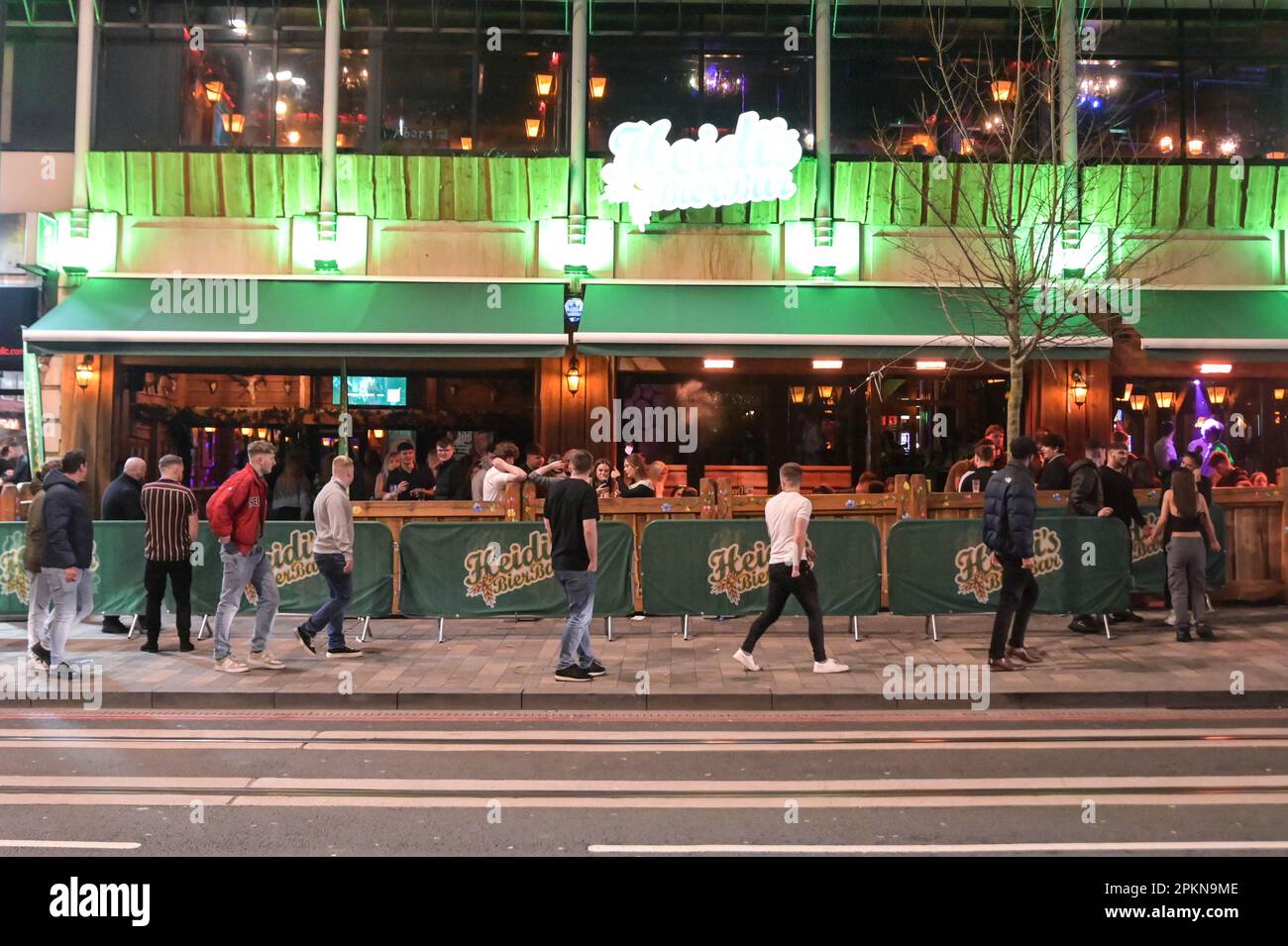 Broad Street, Birmingham, 9th April 2023 Revellers walk past Heidi's