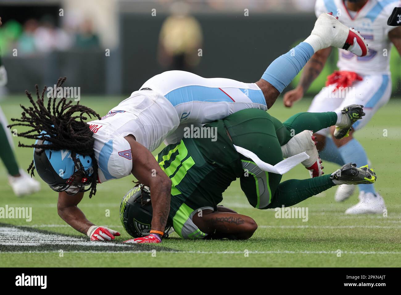 April 8, 2023: Orlando Guardians wide receiver DEDDRICK THOMAS (10) gets tackled by Arlington Renegades defensive back JOE POWELL (4) during the Orlando Guardians vs Arlington Renegades XFL game at Camping World Stadium in Orlando, Fl on April 8, 2023. (Credit Image: © Cory Knowlton/ZUMA Press Wire) EDITORIAL USAGE ONLY! Not for Commercial USAGE! Stock Photo