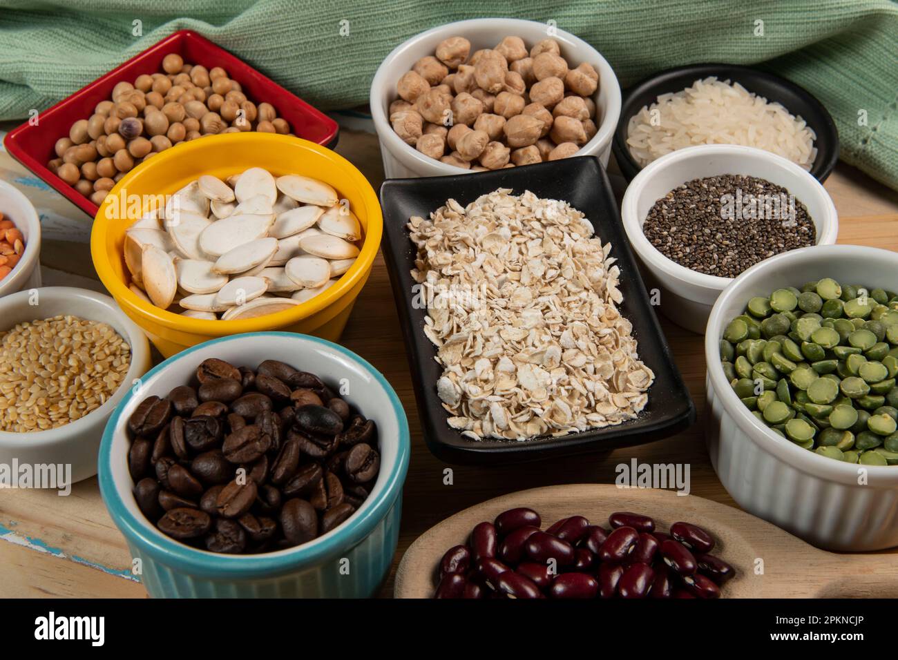 Different types of legumes in bowls, green and yellow peas, chickpeas