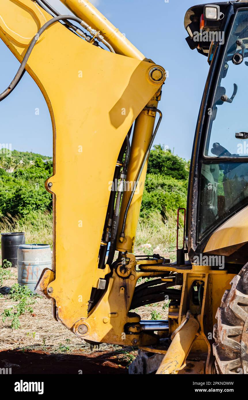 The backhoe boom, hoses, cables and cylinders that connects to the cab